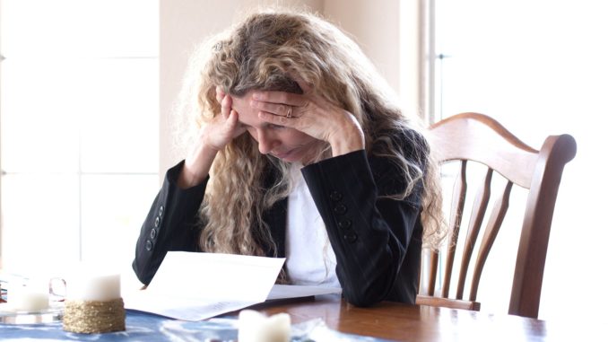 woman worried about bills and debt and foreclosure